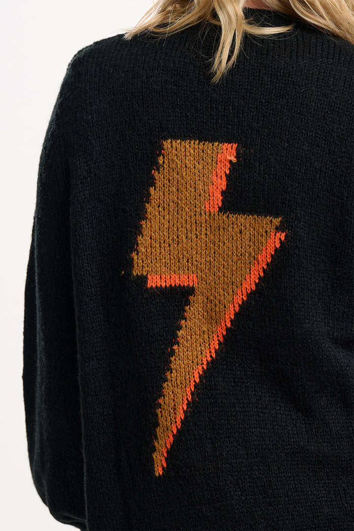 Black sweater with a brown and red lightning bolt design on a white background