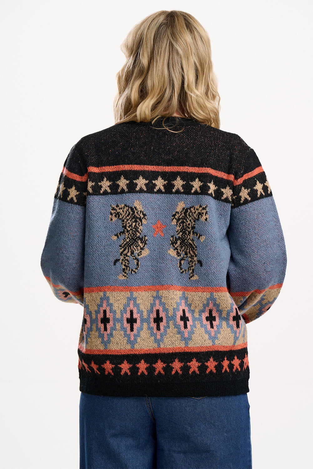 Person wearing a patterned sweater with a white background