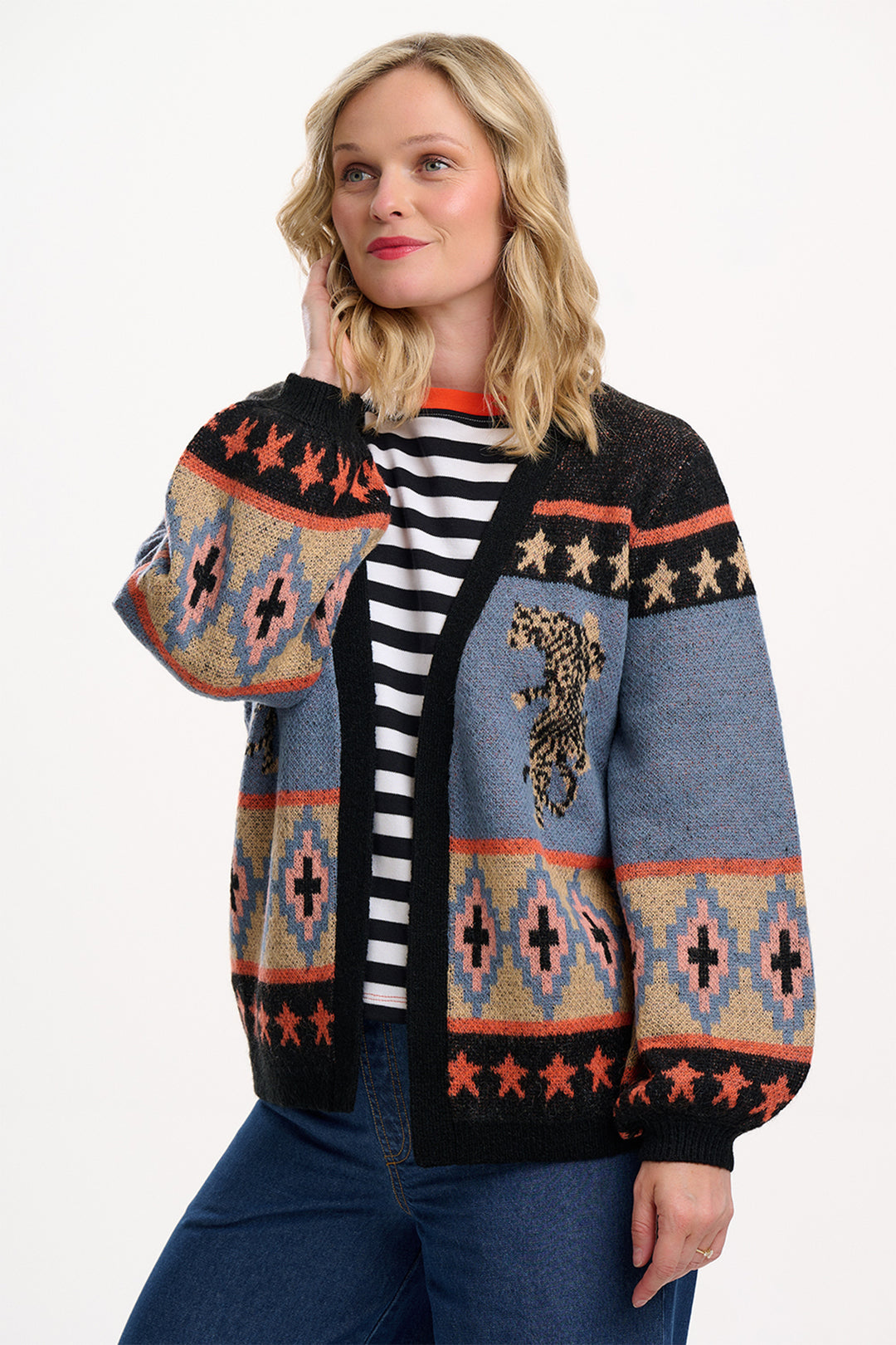 Woman wearing a patterned cardigan with a white background