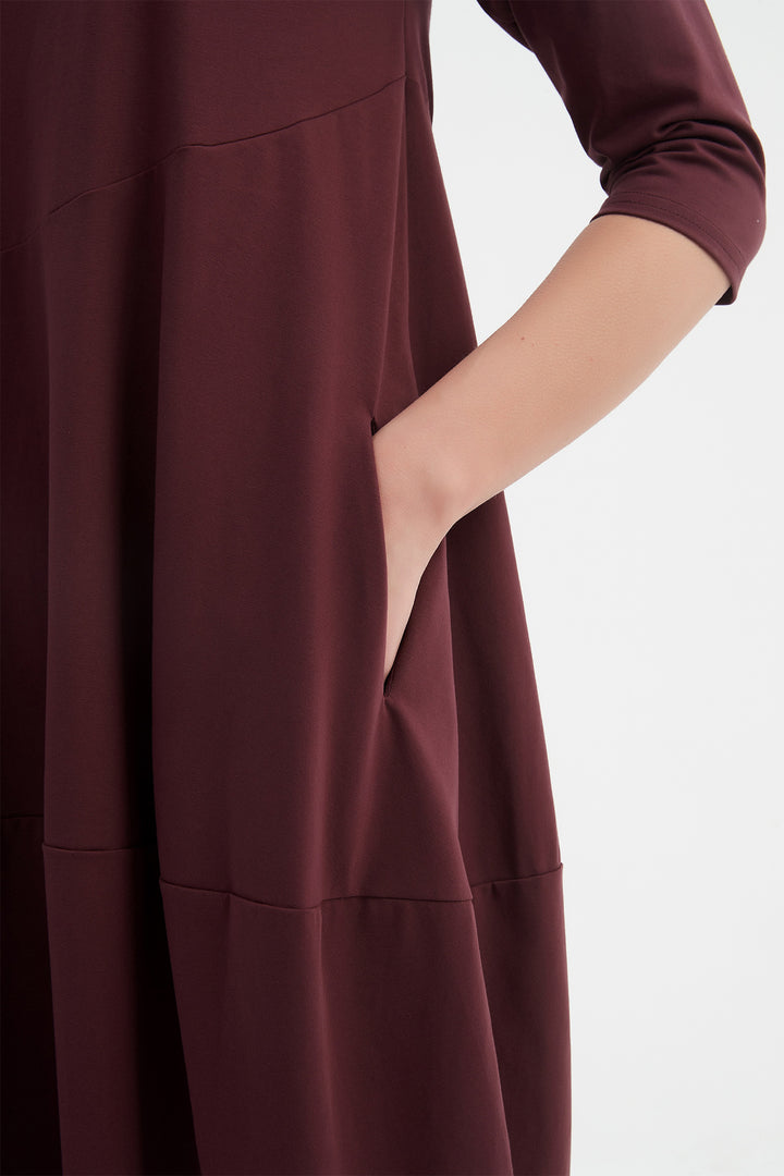 Maroon dress with a plain background