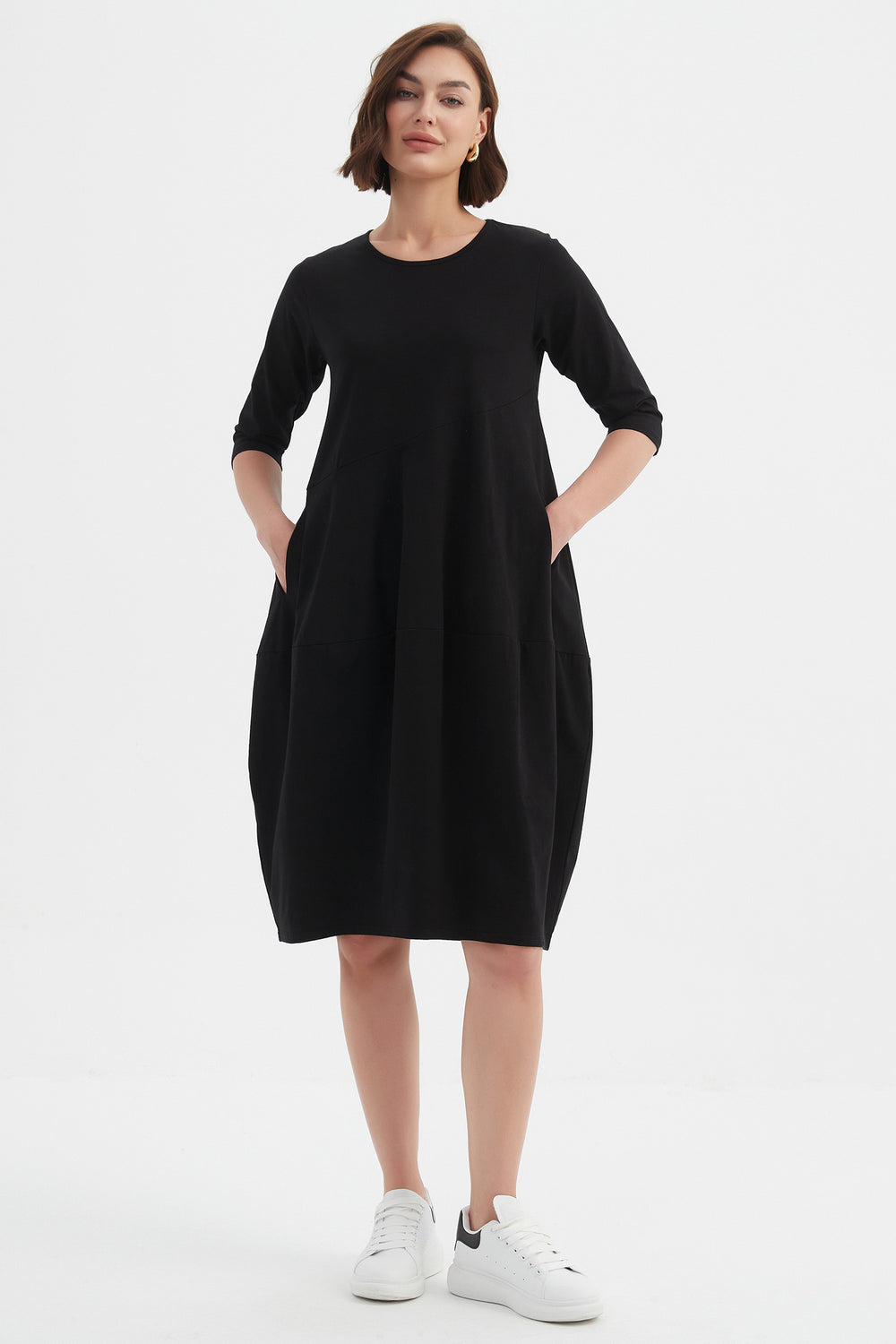 Woman wearing a black dress on a white background