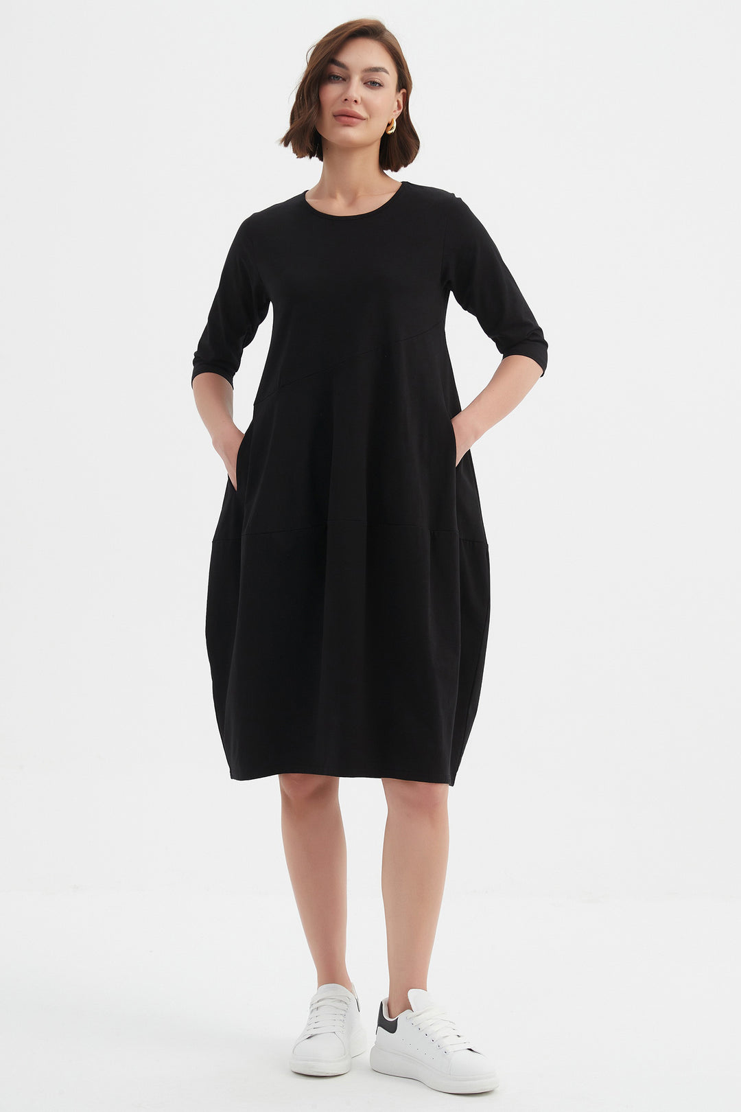Woman wearing a black dress on a white background
