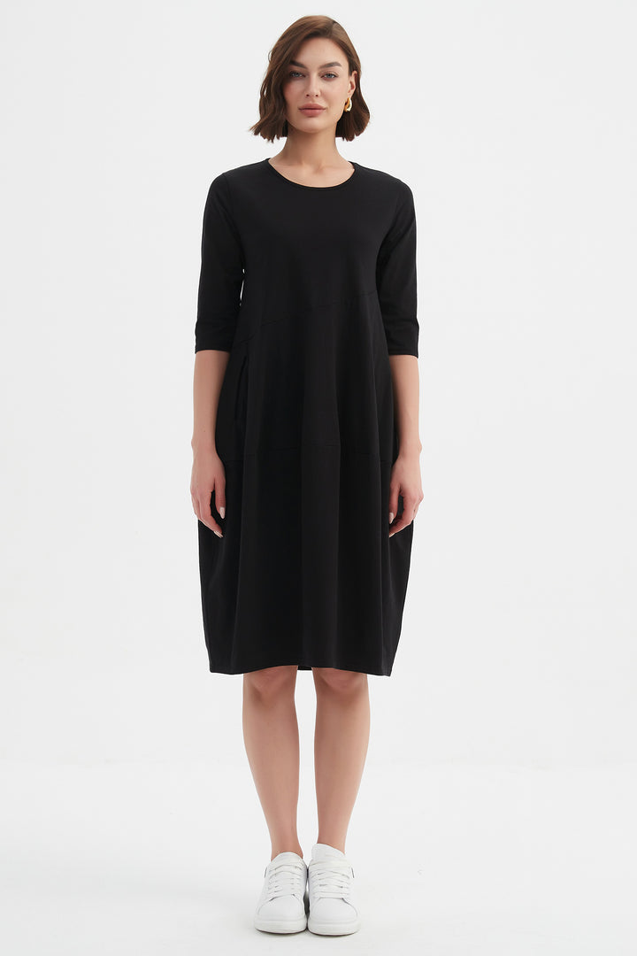 Woman wearing a black dress on a white background