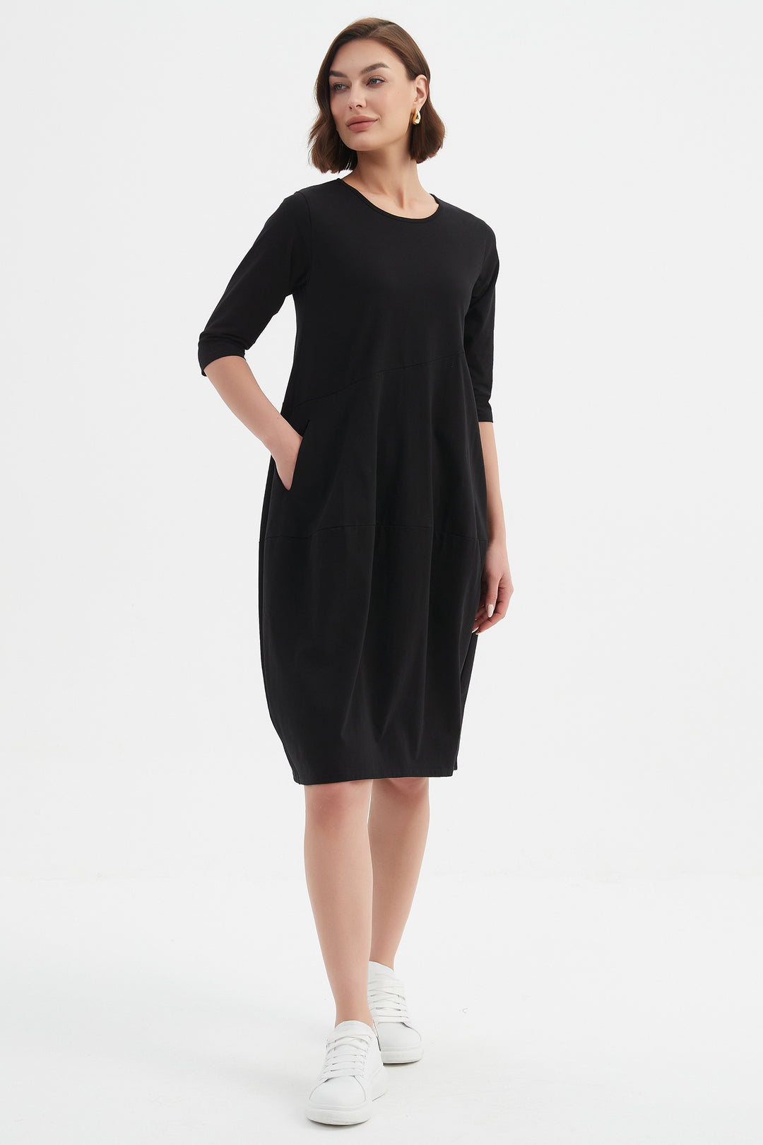 Woman wearing a black dress on a white background