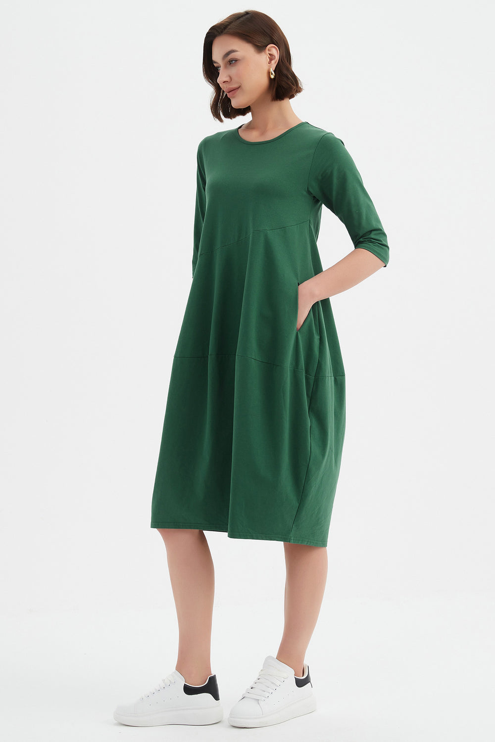 Woman wearing a green dress on a white background