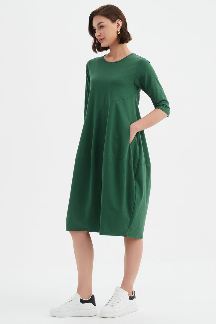 Woman wearing a green dress on a white background