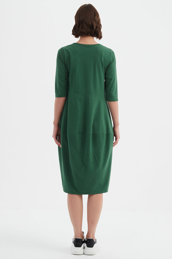 Person wearing a green dress on a white background