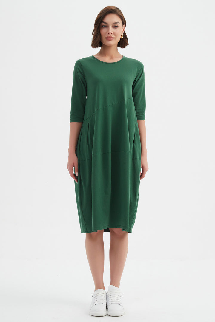 Woman wearing a green dress on a white background