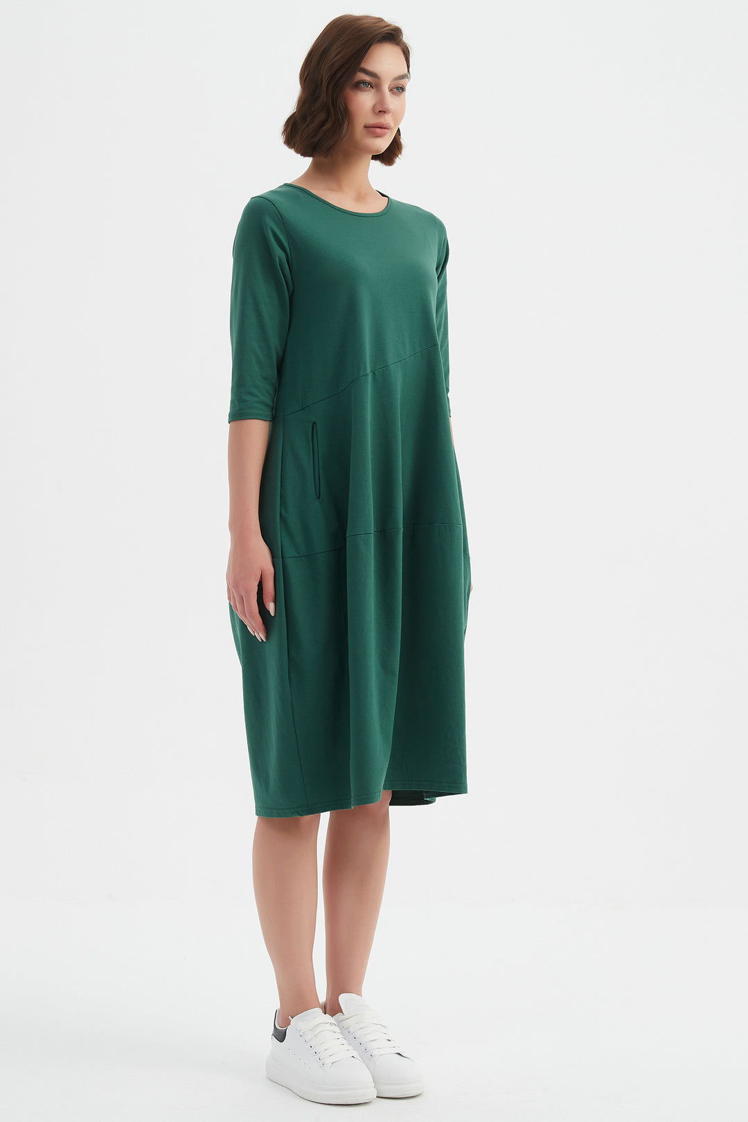 Woman wearing a green dress on a white background