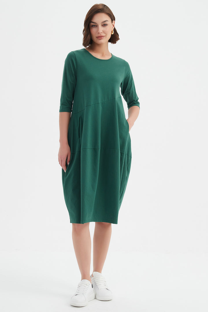 Woman wearing a green dress on a white background