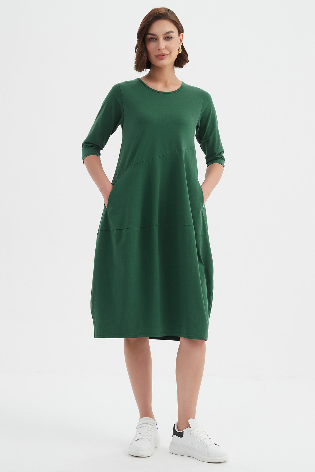 Woman wearing a green dress on a white background