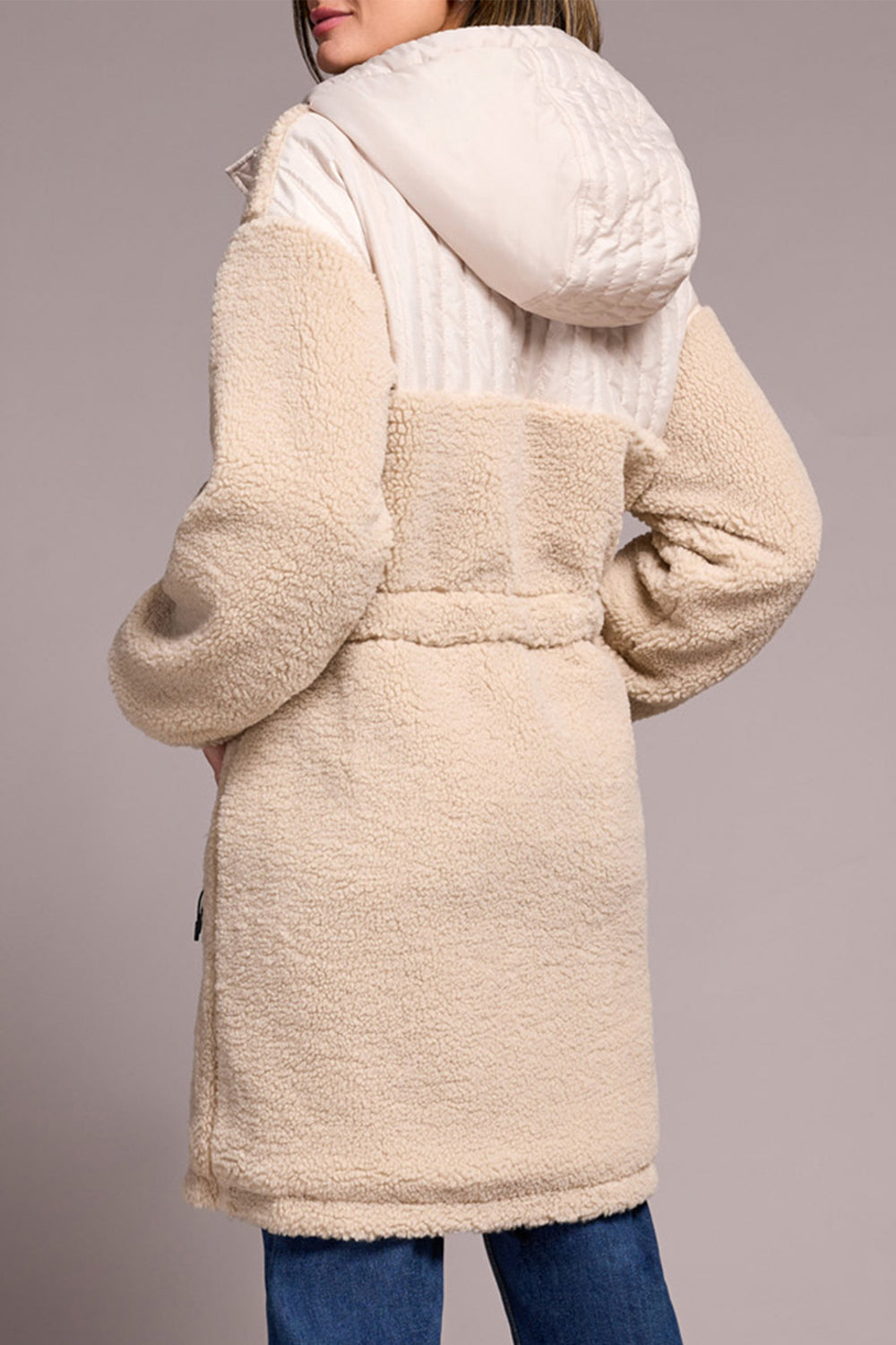 Beige sherpa coat with hood on a plain background