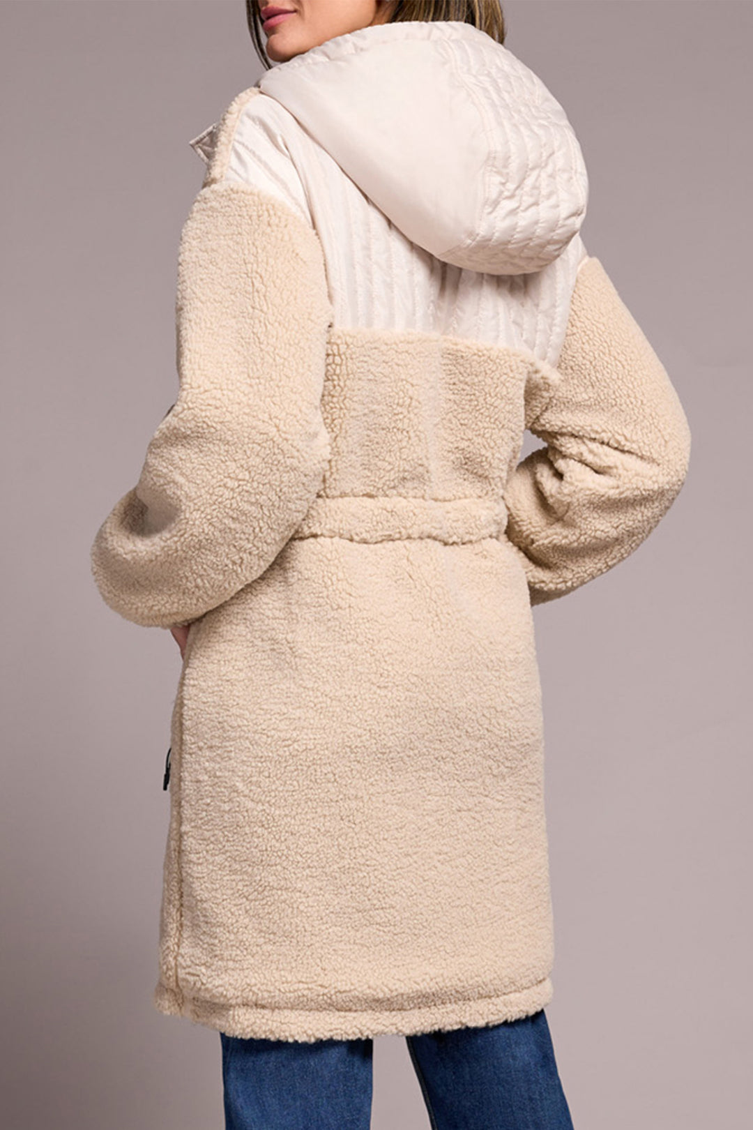 Beige sherpa coat with hood on a plain background