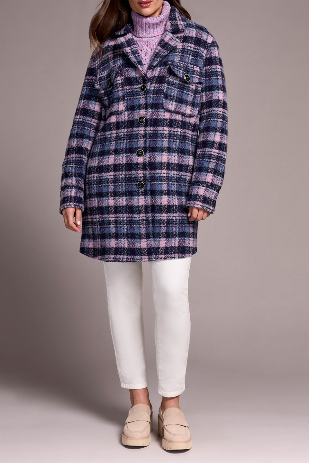 Person wearing a plaid coat with a plain background